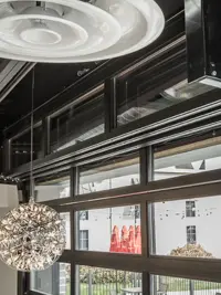 Clopay VertiStack Clear doors stacked open at the Bangkok Thai Restaurant, creating a seamless indoor-outdoor dining space.