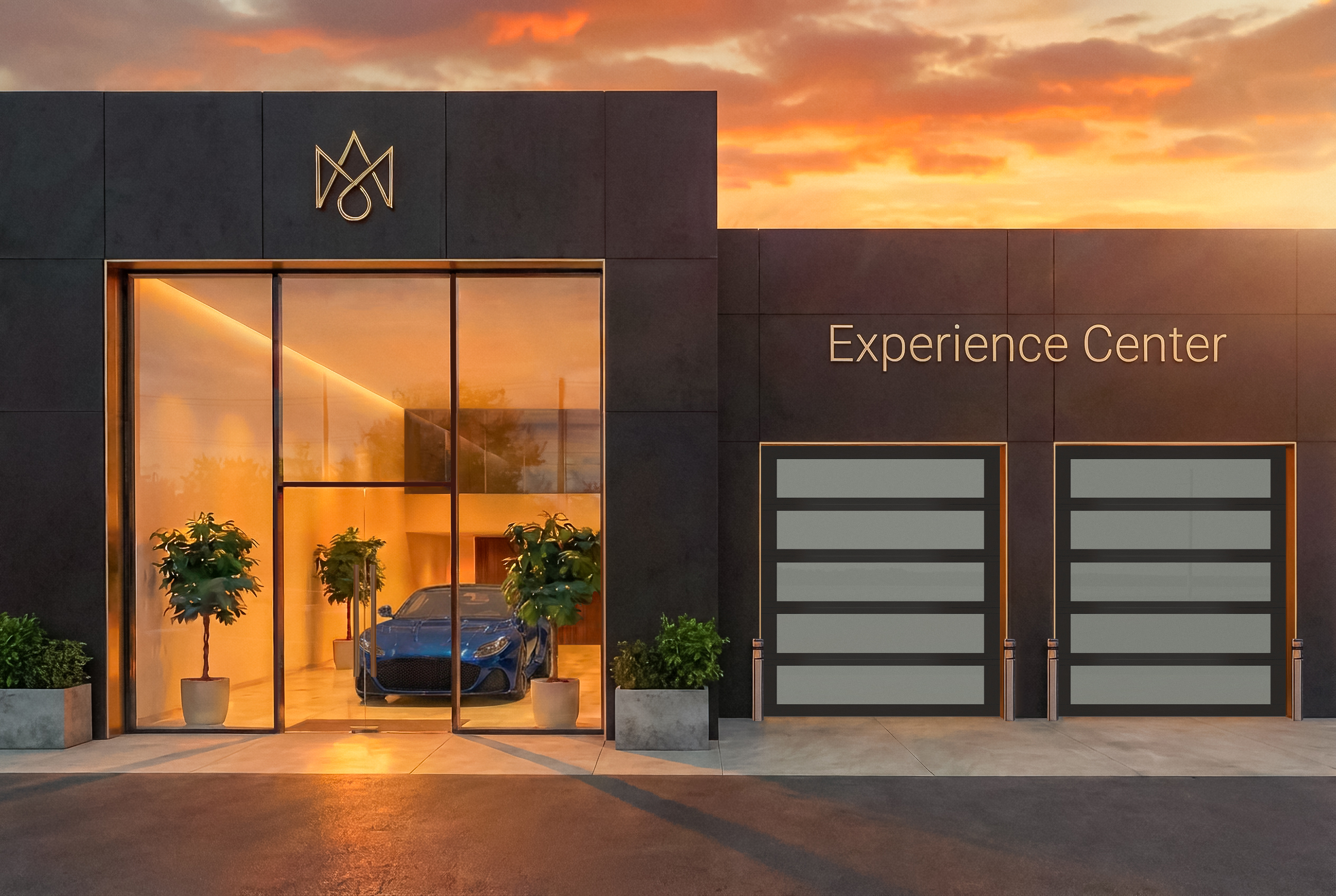 Sun casts a warm orange glow on a gray modern building featuring two opaque commercial garage doors.
