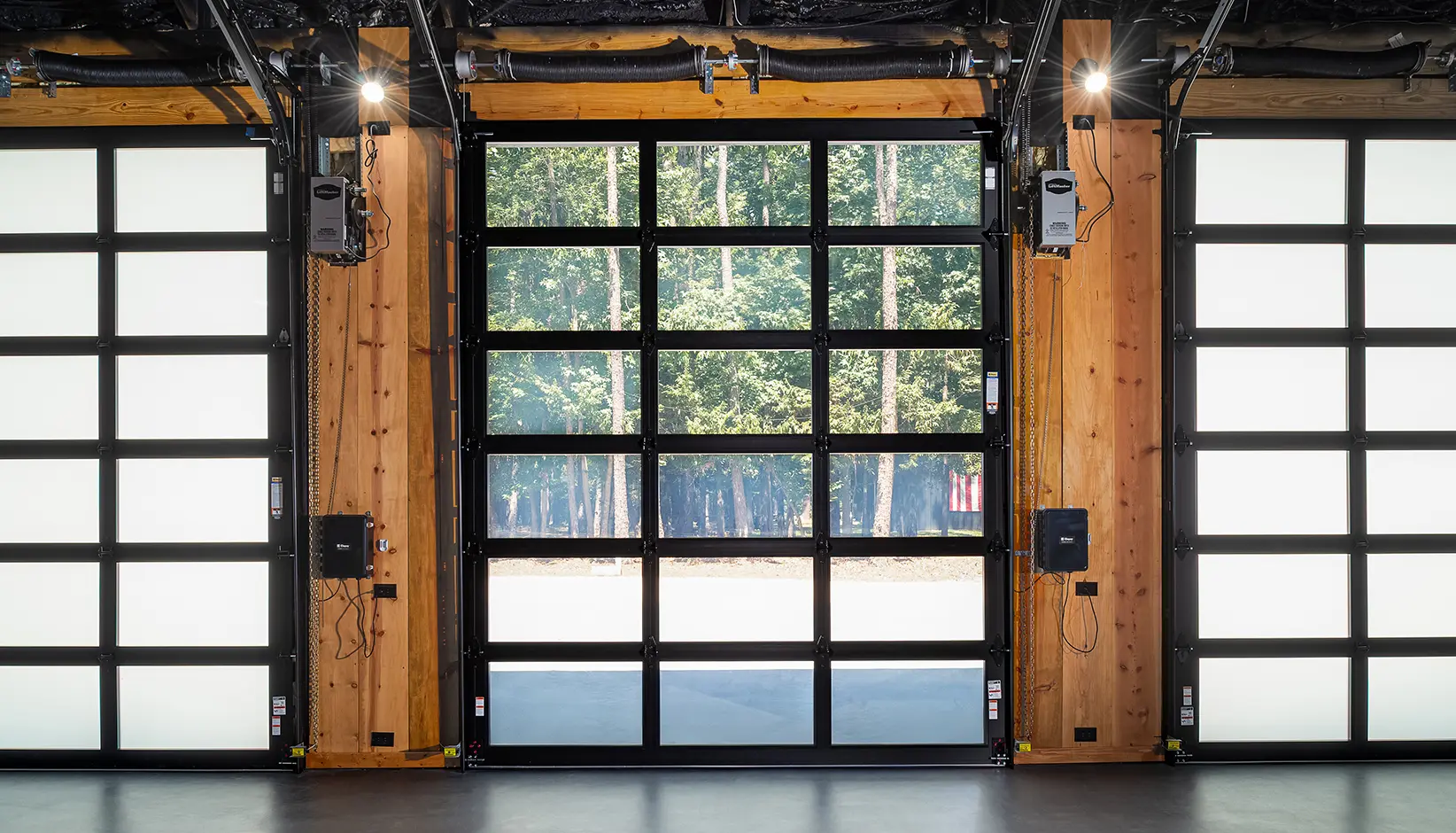 C-Power™ enabled Click-to-Conceal™ panels in Clear/White Opaque laminated glass in a black anodized aluminum frame