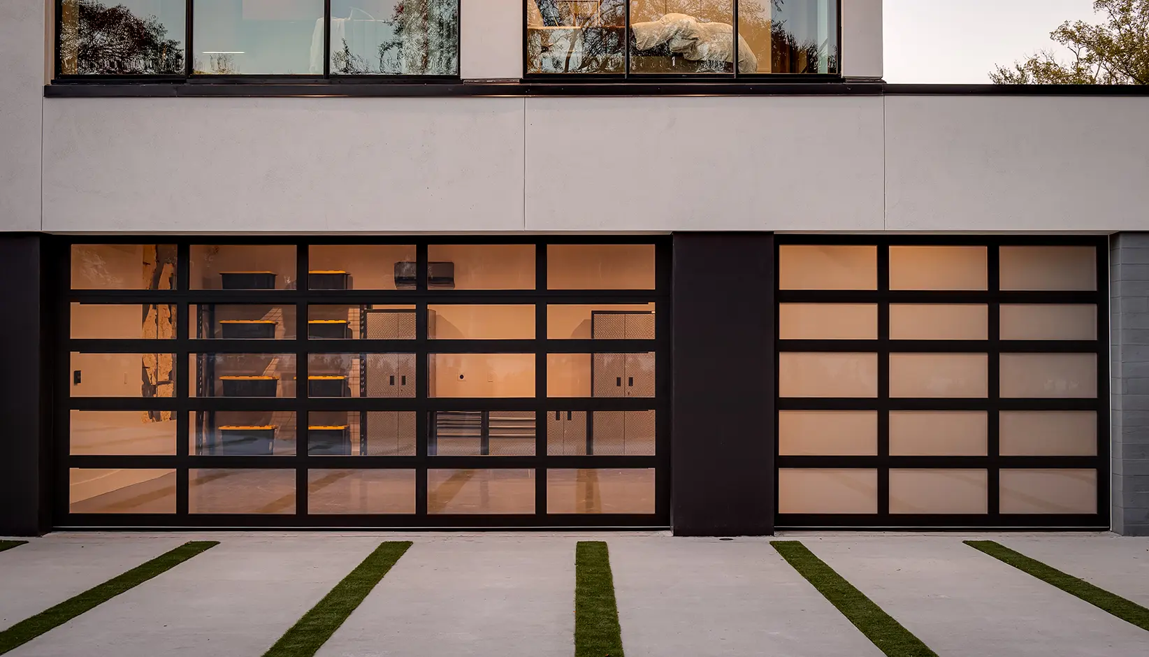 Avante® garage door with C-Power enabled Click-to-Conceal panels in Clear/White Opaque laminated glass in a black anodized aluminum frame