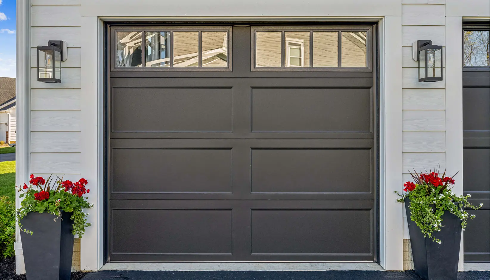 Bridgeport Steel garage door with extended panels and REC14 windows in Lustra™ black