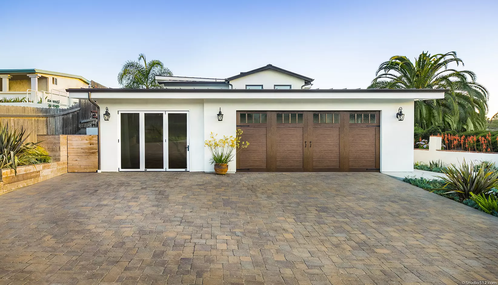 Canyon Ridge® 4-Layer garage door in Design 11 with REC14 windows in Ultra-Grain® Cypress Dark Finish.