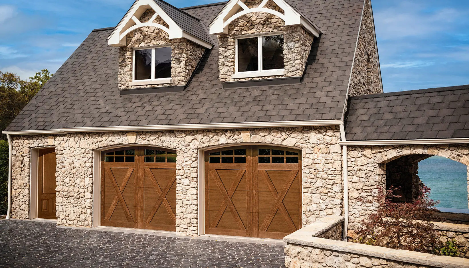 Canyon Ridge® 4-Layer garage door in Design 21 with ARCH3 windows in Ultra-Grain® Cypress Dark finish