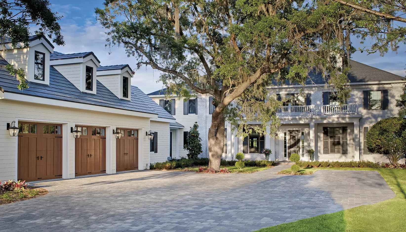 Canyon Ridge 5-Layer Carriage House door, Design 13 REC 13 windows with Mahogany cladding and overlays in the Dark stain finish