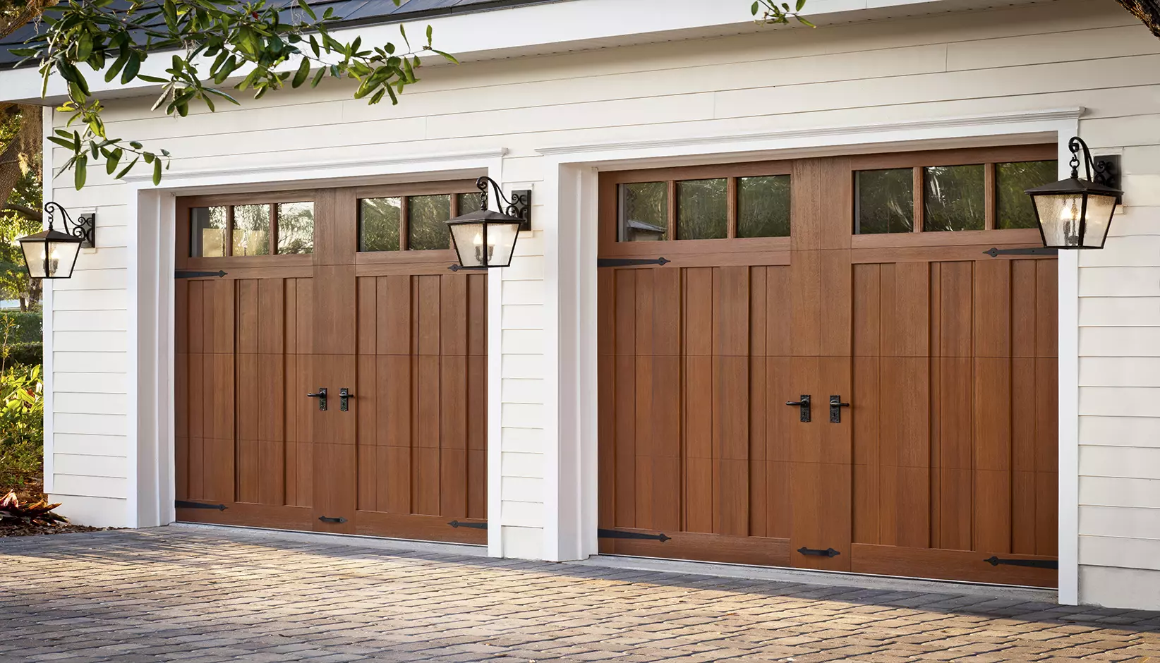 Canyon Ridge 5-Layer Carriage House door, Design 13 REC 13 windows with Mahogany cladding and overlays in the Dark stain finish
