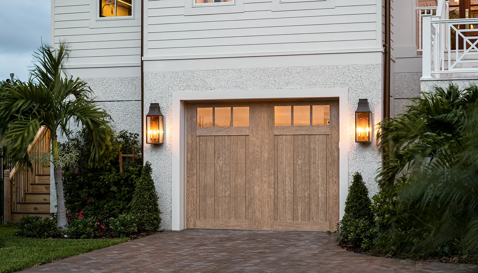 Canyon Ridge® 5-Layer garage door in Design 11 with REC13 windows in Natural Finish