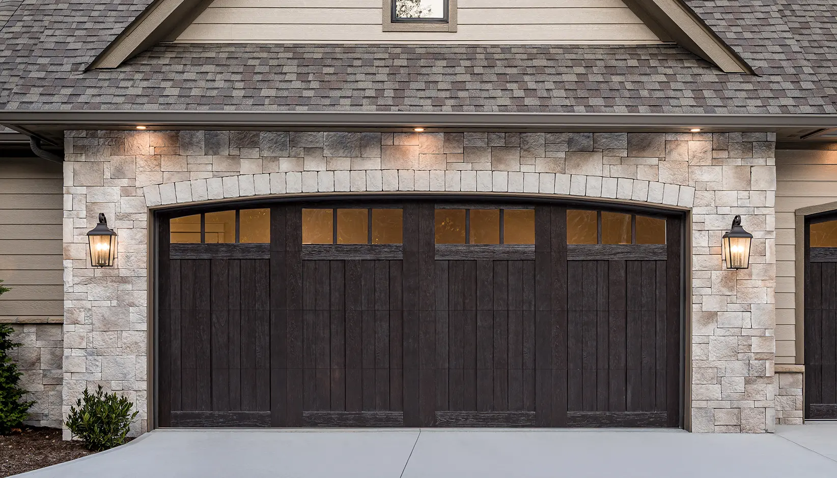 Canyon Ridge® 5-Layer garage door in Design 11 with ARCH13A windows in Espresso Finish