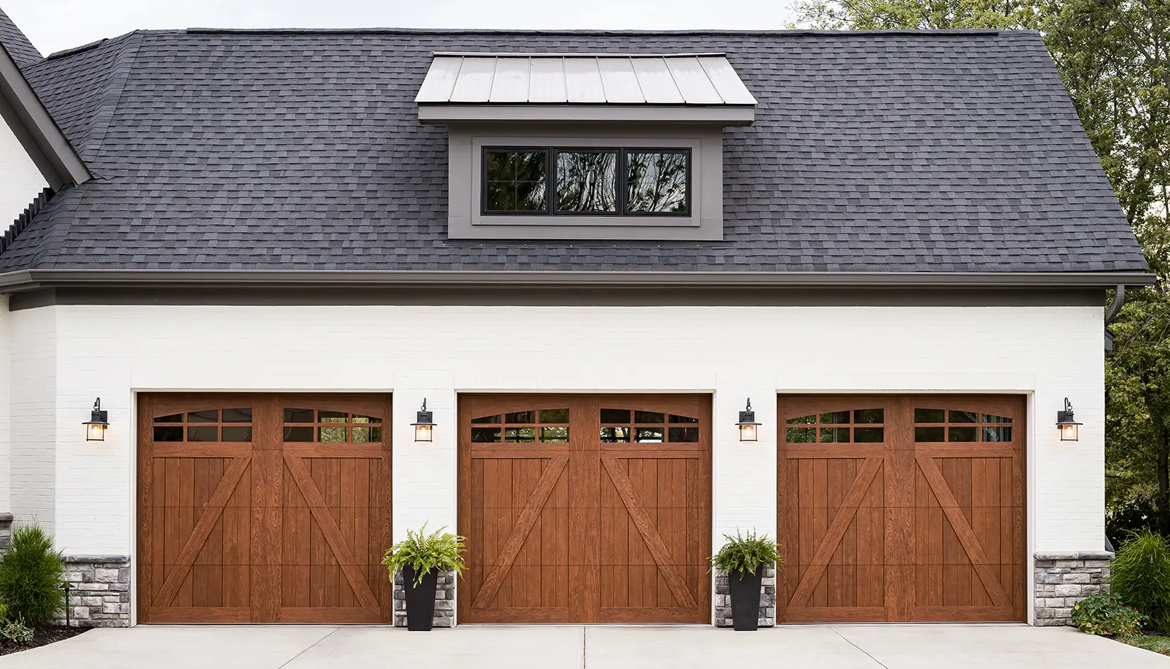 Canyon Ridge 5-Layer garage door in Design 22 with ARCH3 windows in Medium Finish