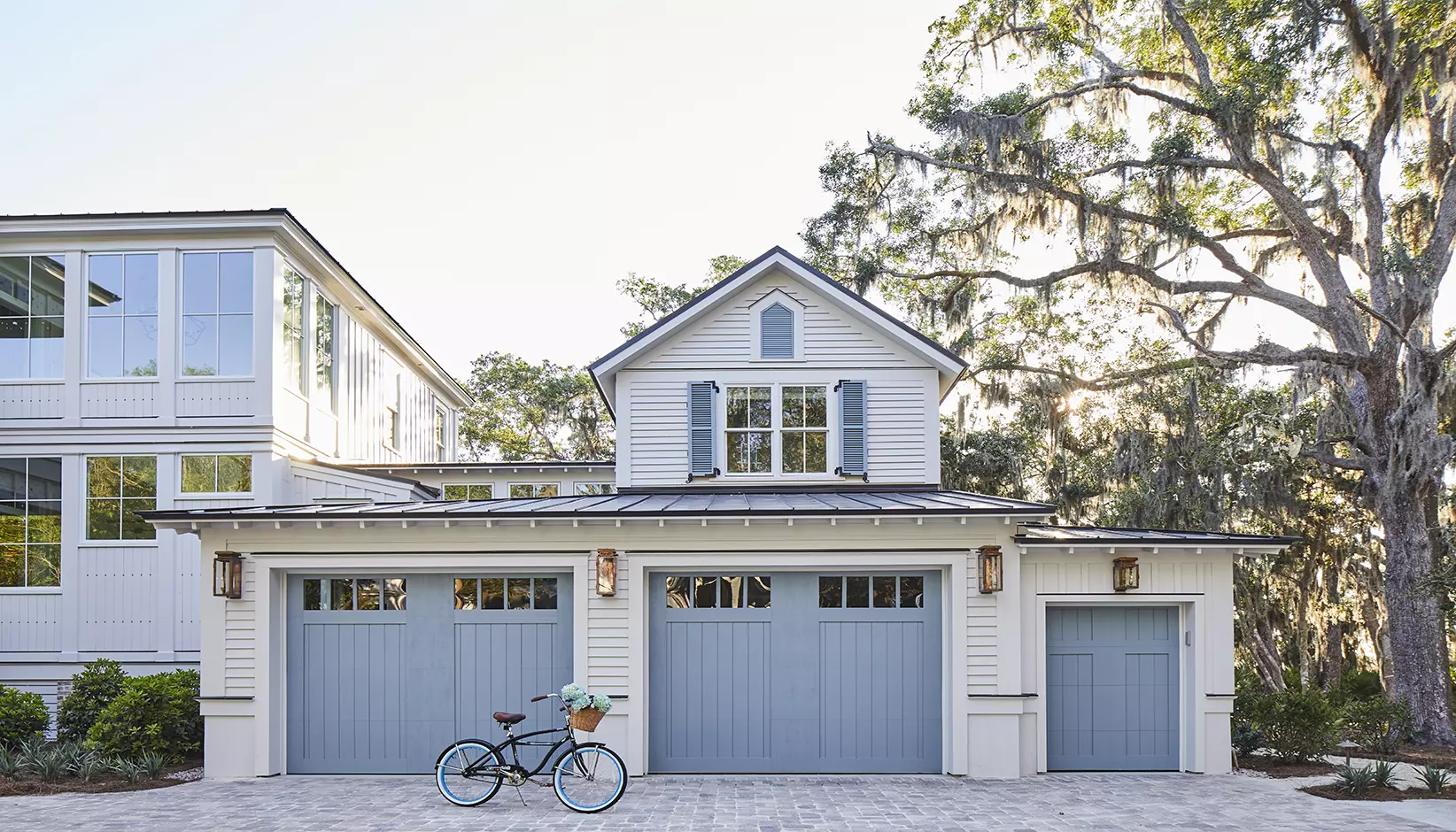 Canyon Ridge 5-Layer garage door in Design 11 with REC14 windows in Sherwin Williams Debonair