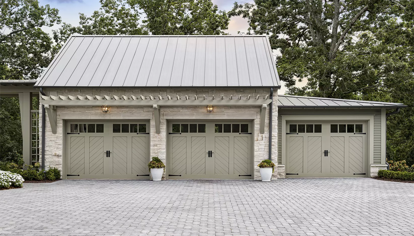Canyon Ridge® Chevron garage door in Design 12, Option A with REC14 windows in Sherwin Williams Rushing River