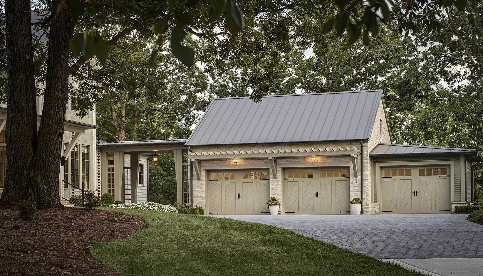 Canyon Ridge Chevron garage door in Design 12, Option A with REC14 windows in Sherwin Williams Rushing River
