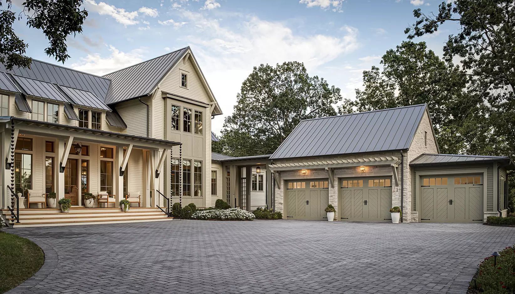 Canyon Ridge® Chevron garage door in Design 12, Option A with REC14 windows in Sherwin Williams Rushing River
