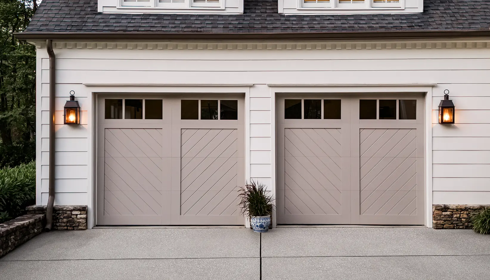 Canyon Ridge Chevron garage door in Design 11 with REC13 windows in Sherwin Williams Requisite Gray