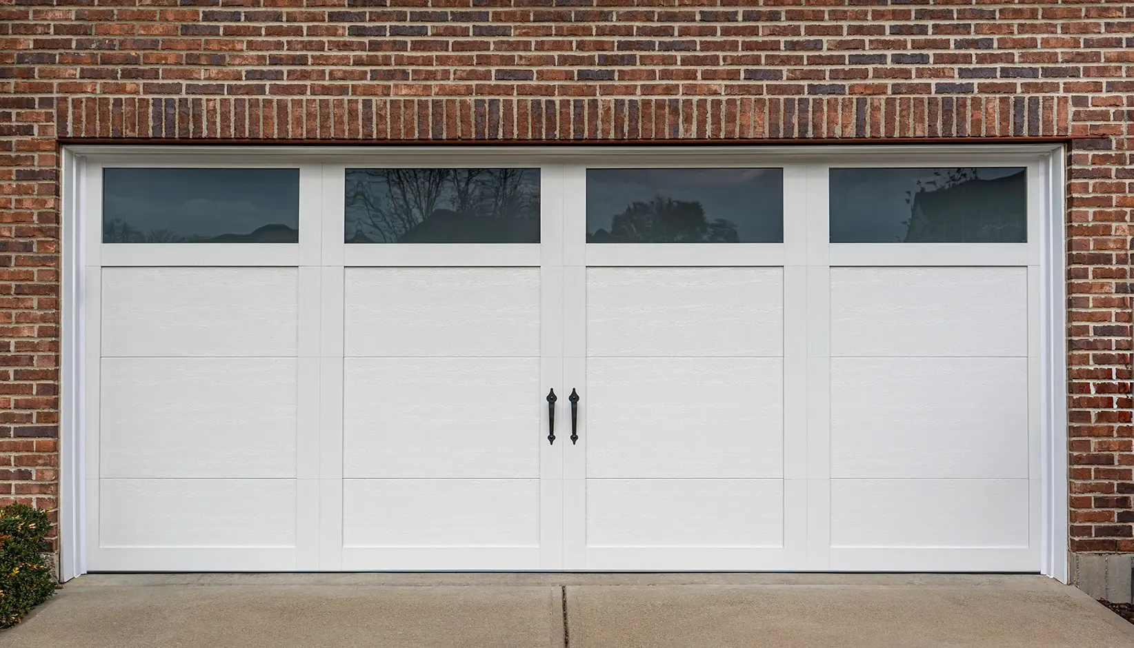 Canyon Ridge® Elements garage door in Design 11 with REC11 windows in White