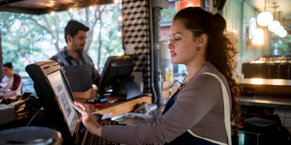 woman and man at computers at service area in restaurant